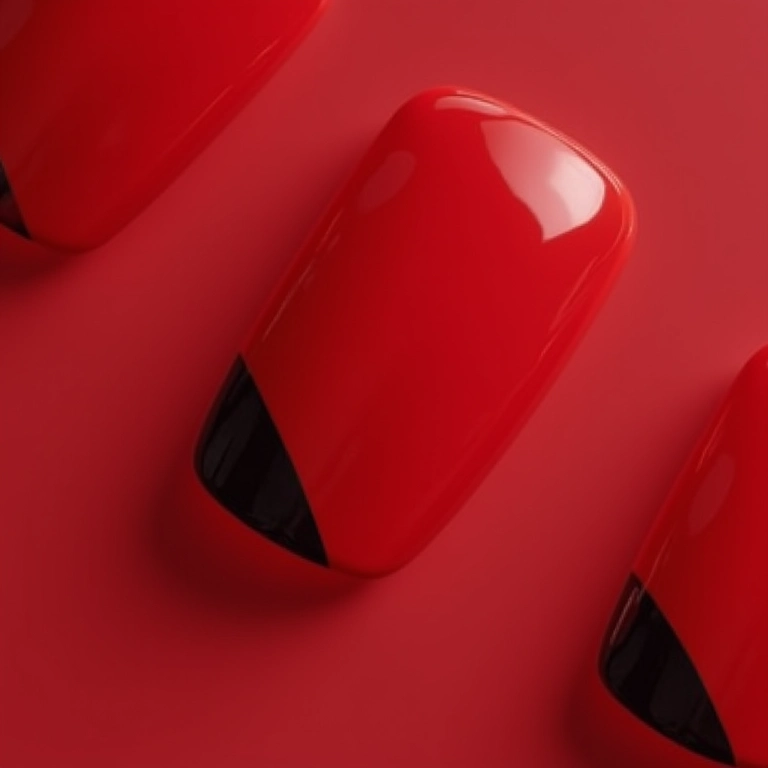 Unhas vermelhas com detalhes em preto, contraste marcante.